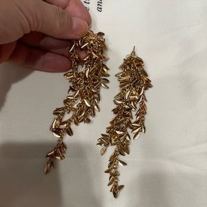 Gold long statement earrings.